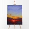 Blazing Skies Oil Painting Sky Landscape by Andrew Gaia on easel. Painting of the warm sunrise cutting through the clouds to reveal the cool blue sky.